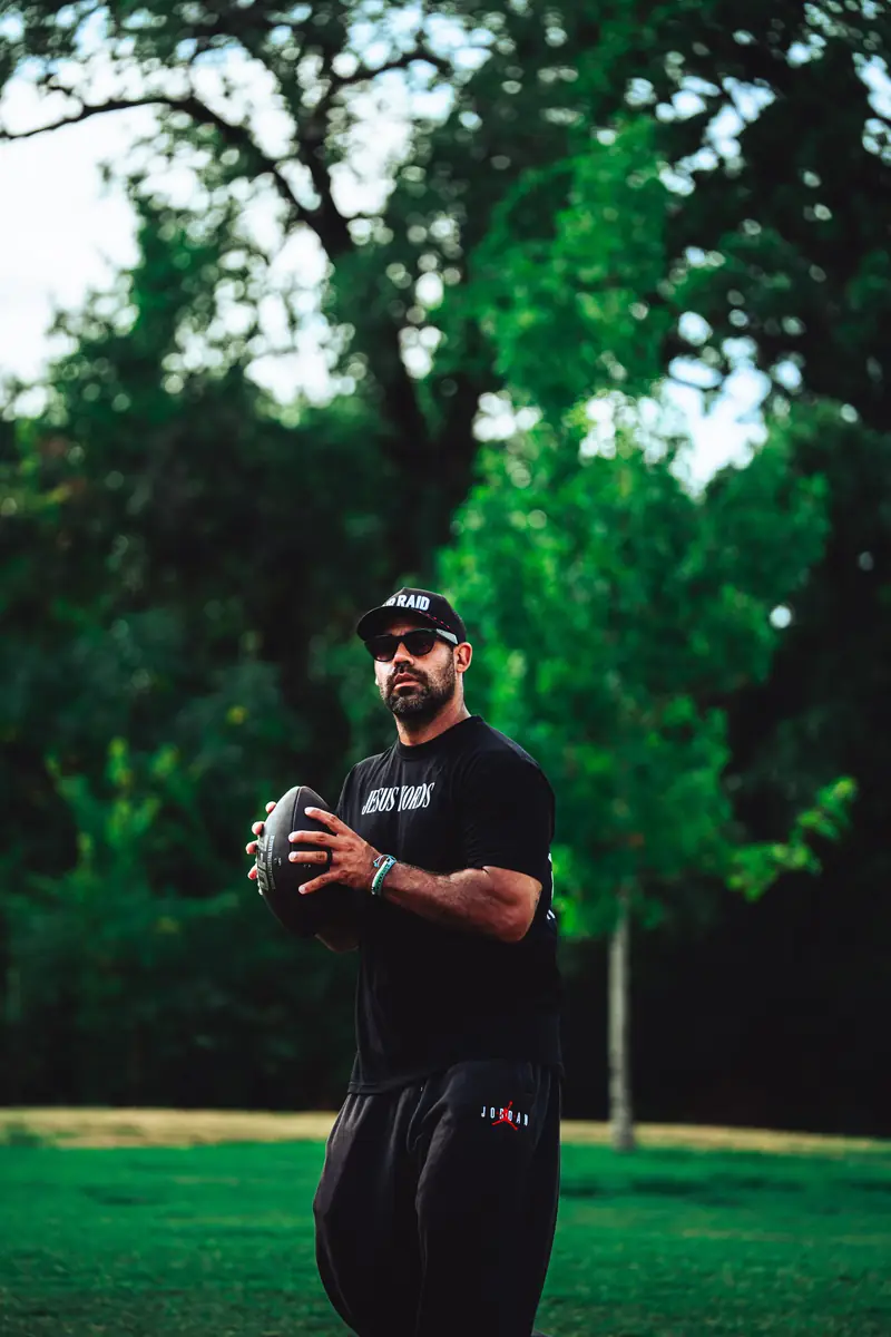 Craig LeBlanc, 2 Live Craig, football mentor holding a football outdoors in Northlake, TX