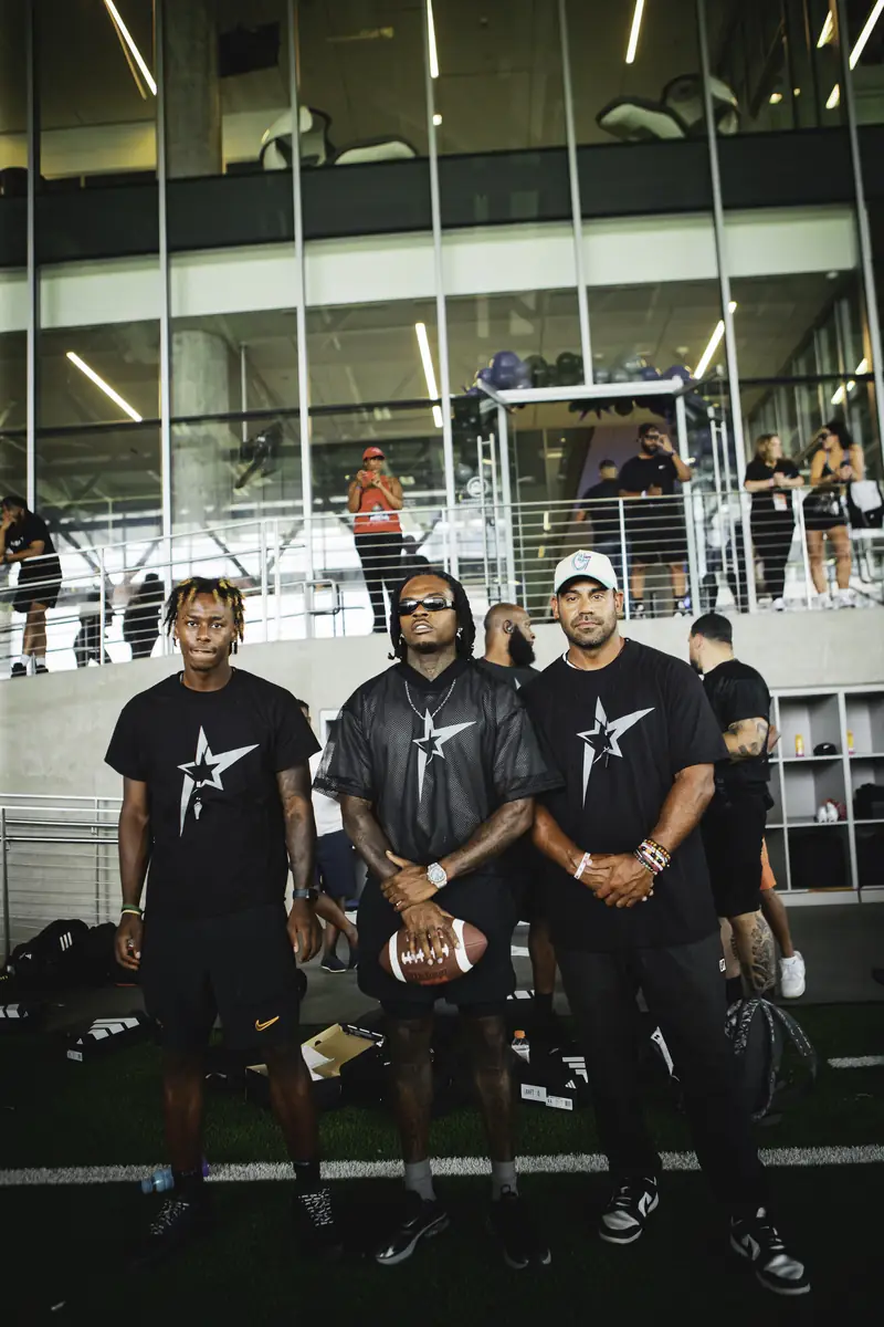 Craig LeBlanc with football players at a star-logo team event